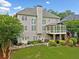 Exterior view of a home featuring a well-manicured backyard and a sunroom at 580 River Valley Dr, Dacula, GA 30019