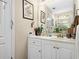 Bathroom vanity with white cabinets, marble countertops, and decorative items at 580 River Valley Dr, Dacula, GA 30019