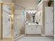 Bright bathroom featuring a glass shower, neutral tones, and a white vanity at 580 River Valley Dr, Dacula, GA 30019
