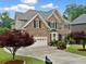 Charming brick home featuring a well-manicured lawn, lush landscaping, and a two-car garage, offering curb appeal at 580 River Valley Dr, Dacula, GA 30019