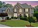 Charming brick home with mature trees and beautifully landscaped front yard at 580 River Valley Dr, Dacula, GA 30019