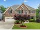 Beautiful brick home with manicured lawn and mature landscaping in a friendly neighborhood at 580 River Valley Dr, Dacula, GA 30019