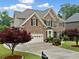 Traditional two-story brick home with manicured lawn and mature trees at 580 River Valley Dr, Dacula, GA 30019