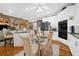 Modern eat-in kitchen featuring white cabinets, stainless steel appliances, and a breakfast nook at 580 River Valley Dr, Dacula, GA 30019