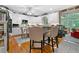 Spacious white kitchen with breakfast bar, stainless appliances, and view to adjoining sunroom at 580 River Valley Dr, Dacula, GA 30019