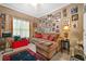 Inviting living room featuring a comfortable sofa, ottoman, area rug, and a gallery wall of Gathering photos at 580 River Valley Dr, Dacula, GA 30019