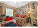 Living room featuring a brown sofa with decorative pillows and many Gathering photos at 580 River Valley Dr, Dacula, GA 30019