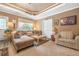 Inviting living room with custom ceiling, a comfortable sectional sofa, and an open layout, perfect for relaxing at 580 River Valley Dr, Dacula, GA 30019