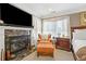 Main bedroom featuring a fireplace, bedside tables, and a large television at 580 River Valley Dr, Dacula, GA 30019