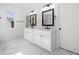 Bright Primary bathroom featuring double vanity, modern fixtures, framed mirrors and sleek marble floor at 2477 Bobbie Dr, Marietta, GA 30066