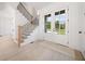 Spacious foyer with light hardwood floors, staircase, and double front doors with glass panels at 2477 Bobbie Dr, Marietta, GA 30066