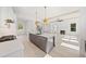 Stylish kitchen with white cabinets, stainless steel appliances, a gray island, and open to the living room at 2477 Bobbie Dr, Marietta, GA 30066