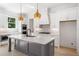 Beautiful kitchen with white cabinets, quartz countertops, stainless steel appliances, and a gray island at 2477 Bobbie Dr, Marietta, GA 30066