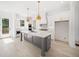 Modern kitchen with white cabinets, stainless steel appliances, a gray island, and hardwood floors at 2477 Bobbie Dr, Marietta, GA 30066