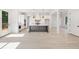 Spacious open-concept kitchen with white cabinets, a gray island, stainless steel appliances, and hardwood floors at 2477 Bobbie Dr, Marietta, GA 30066