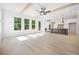 Open-concept living room flows into a kitchen, featuring hardwood floors, wooden beams, and plenty of sunlight at 2477 Bobbie Dr, Marietta, GA 30066