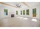 Bright living room with a fireplace, hardwood floors, large windows, and access to a porch at 2477 Bobbie Dr, Marietta, GA 30066