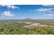 Scenic aerial view of the neighborhood with lush trees and a distant mountain at 4698 Fellsridge Dr, Stone Mountain, GA 30083