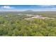 Expansive aerial view of a residential neighborhood, lush trees, and mountains in the distance at 4698 Fellsridge Dr, Stone Mountain, GA 30083