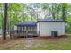 Backyard features a deck, screened-in porch, and wooded view at 4698 Fellsridge Dr, Stone Mountain, GA 30083