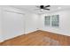 Clean bedroom featuring a ceiling fan, hardwood floors, and a closet at 4698 Fellsridge Dr, Stone Mountain, GA 30083