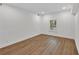 Bedroom features wood-look floors, white walls, and a window providing natural light at 4698 Fellsridge Dr, Stone Mountain, GA 30083