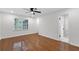 Bedroom featuring hardwood floors, a ceiling fan, and an attached bathroom at 4698 Fellsridge Dr, Stone Mountain, GA 30083