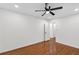 Bright bedroom with hardwood floors, white walls, and a ceiling fan at 4698 Fellsridge Dr, Stone Mountain, GA 30083
