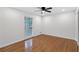 Bright bedroom with hardwood floors, ceiling fan, and natural light at 4698 Fellsridge Dr, Stone Mountain, GA 30083