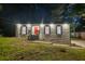 Charming home featuring a bright red front door, windows with shutters, and manicured lawn at 4698 Fellsridge Dr, Stone Mountain, GA 30083