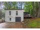 Rear exterior view of the home with a deck and garage at 4698 Fellsridge Dr, Stone Mountain, GA 30083