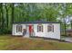 Charming renovated bungalow features a red front door and freshly painted exterior at 4698 Fellsridge Dr, Stone Mountain, GA 30083