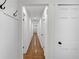 Long hallway showing access to bedrooms and hardwood floors at 4698 Fellsridge Dr, Stone Mountain, GA 30083