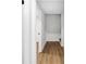 Hallway features wood-look floors, white trim, neutral paint, and several doorways at 4698 Fellsridge Dr, Stone Mountain, GA 30083