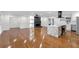 Spacious open living area with hardwood floors, modern kitchen, and elegant fireplace at 4698 Fellsridge Dr, Stone Mountain, GA 30083