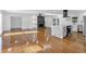 Open-concept living area with hardwood floors, fireplace, and updated kitchen at 4698 Fellsridge Dr, Stone Mountain, GA 30083