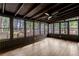 Enclosed porch area with view of backyard and wooden deck at 4698 Fellsridge Dr, Stone Mountain, GA 30083