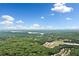 Breathtaking aerial view showcasing the neighborhood, with beautiful lake and mountain views in the distance at 221 Creekside Pass Pass, Canton, GA 30114