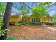 Well-maintained backyard featuring black metal fencing, landscaping, and views of the home's exterior at 221 Creekside Pass Pass, Canton, GA 30114