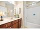 Comfortable bathroom with single sink vanity, tile flooring, and a shower with a tub at 221 Creekside Pass Pass, Canton, GA 30114