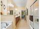 Bright bathroom featuring a double sink vanity, walk-in shower, and separate soaking tub at 221 Creekside Pass Pass, Canton, GA 30114