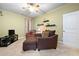 Cozy bedroom with an accent chair, a small TV on an entertainment center, and a large door at 221 Creekside Pass Pass, Canton, GA 30114