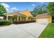 Expansive driveway leading to a two-car garage, lined with manicured greenery and lush lawn at 221 Creekside Pass Pass, Canton, GA 30114