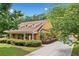 Charming two-story home featuring a welcoming front porch, shuttered windows, landscaping and long driveway at 221 Creekside Pass Pass, Canton, GA 30114