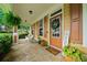 Welcoming front porch with stone flooring, comfortable seating, and decorative accents by the front door at 221 Creekside Pass Pass, Canton, GA 30114