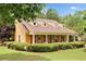 Inviting home exterior featuring dormer windows, manicured hedges, and a welcoming front porch at 221 Creekside Pass Pass, Canton, GA 30114