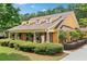 Charming home boasts a cozy front porch, complemented by lush landscaping and inviting curb appeal at 221 Creekside Pass Pass, Canton, GA 30114