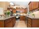 Well-lit kitchen featuring stainless steel appliances, granite countertops, and wooden cabinets at 221 Creekside Pass Pass, Canton, GA 30114