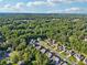 A scenic aerial view showcases a neighborhood's attractive homes and tranquil, wooded surroundings at 2909 Everson Ridge Ct, Snellville, GA 30039