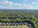 Panoramic aerial view of a residential area surrounded by a vast expanse of lush, green forest at 2909 Everson Ridge Ct, Snellville, GA 30039